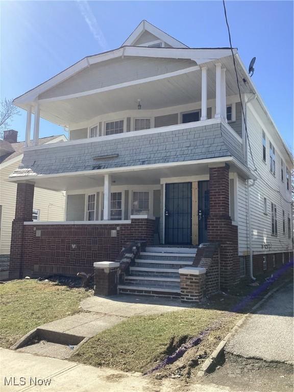 3370 E 145th St, Cleveland, OH 44120 - view of front of home featuring brick siding, covered porch, and roof with shingles