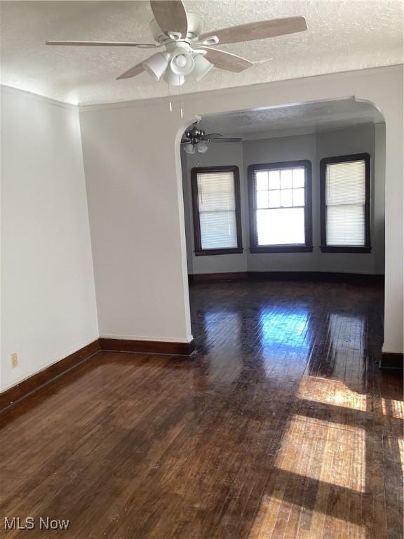 3370 E 145th St, Cleveland, OH 44120 - spare room with baseboards, a textured ceiling, a ceiling fan, and hardwood / wood-style flooring