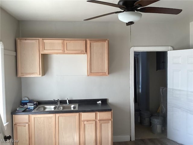3370 E 145th St, Cleveland, OH 44120 - kitchen featuring ceiling fan, dark countertops, light brown cabinetry, and a sink
