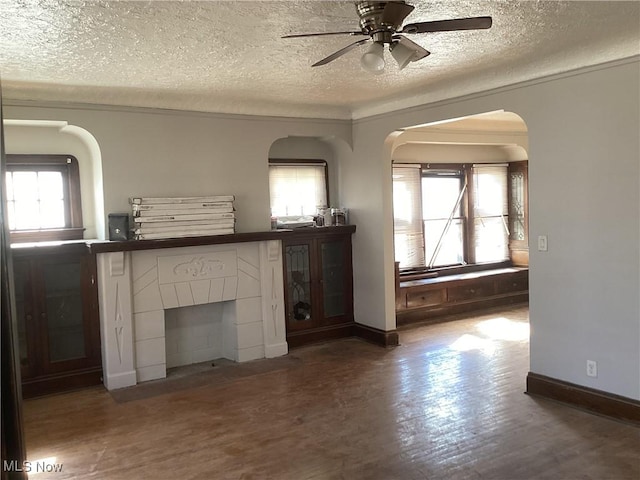 3370 E 145th St, Cleveland, OH 44120 - unfurnished living room featuring a wealth of natural light, arched walkways, wood finished floors, and ceiling fan