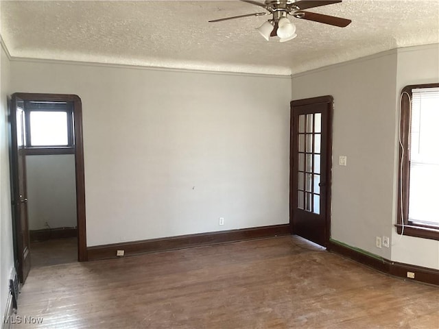 3370 E 145th St, Cleveland, OH 44120 - empty room featuring a ceiling fan, wood finished floors, baseboards, and a textured ceiling