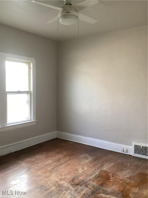 3370 E 145th St, Cleveland, OH 44120 - empty room with dark wood-type flooring, baseboards, visible vents, and ceiling fan