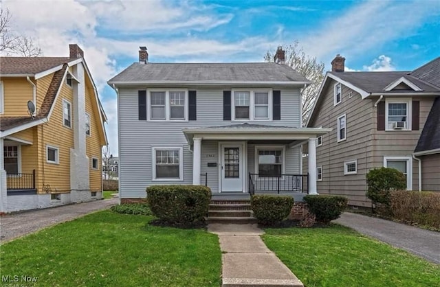 3540 Silsby Rd, Cleveland Heights, OH 44118 - view of front of home with a porch, a chimney, and a front yard
