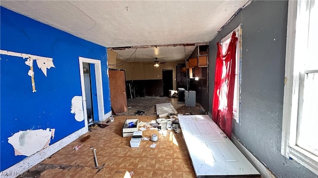interior space with ceiling fan
