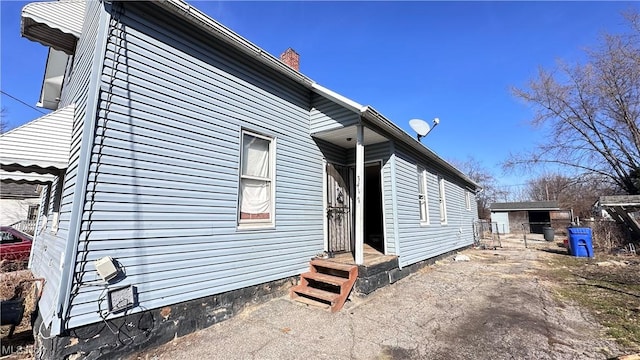 view of side of property with a chimney