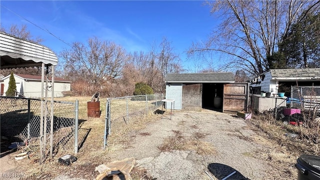 view of yard with an outbuilding, fence, and a shed