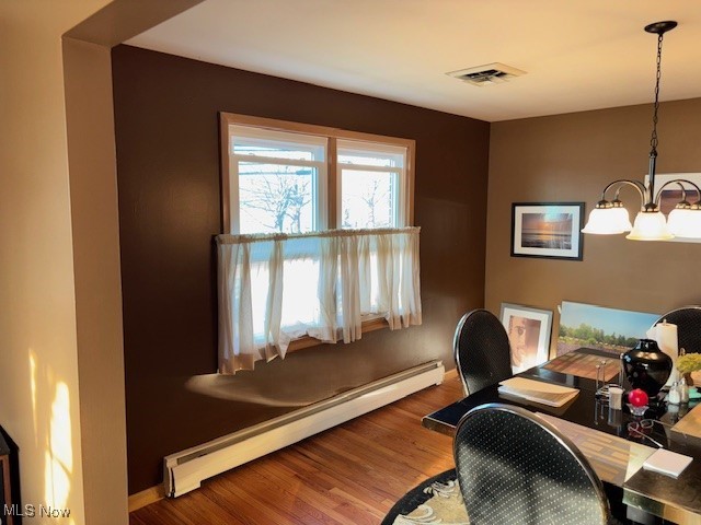 1317 Hartzell, Niles, OH 44446 - home office featuring visible vents, a baseboard heating unit, wood finished floors, an inviting chandelier, and baseboards