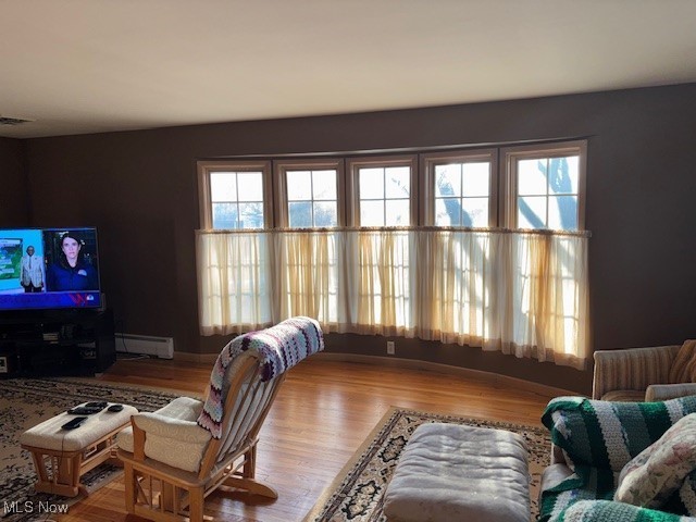 1317 Hartzell, Niles, OH 44446 - living room with a baseboard heating unit, wood finished floors, and visible vents