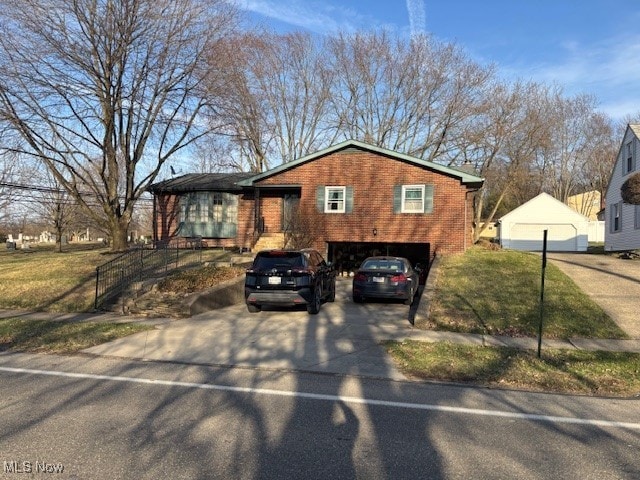 1317 Hartzell, Niles, OH 44446 - view of front facade featuring concrete driveway and brick siding
