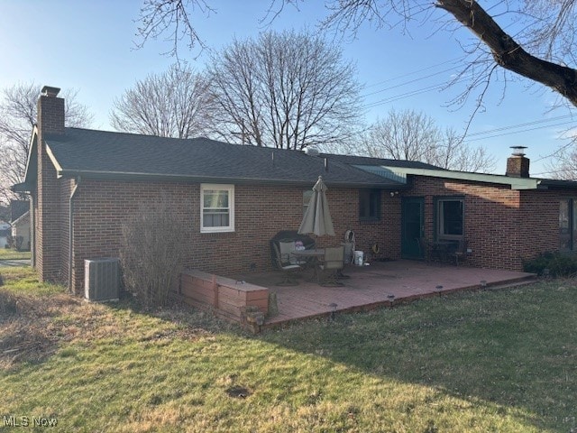 1317 Hartzell, Niles, OH 44446 - rear view of house featuring a lawn, central AC, brick siding, a chimney, and a patio area