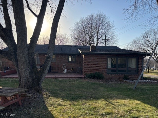 1317 Hartzell, Niles, OH 44446 - back of house with brick siding, a chimney, and a lawn