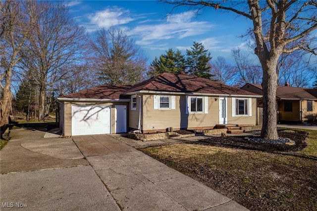 single story home with driveway and a garage