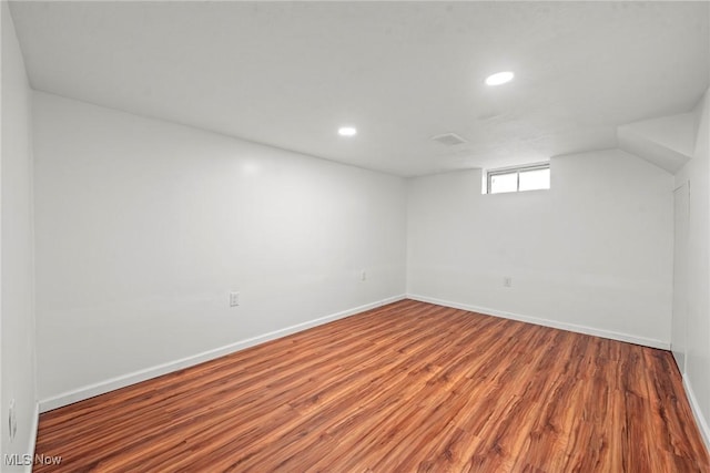 basement featuring baseboards, recessed lighting, and wood finished floors