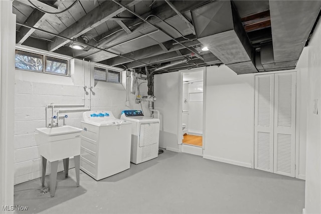 below grade area featuring washer and clothes dryer