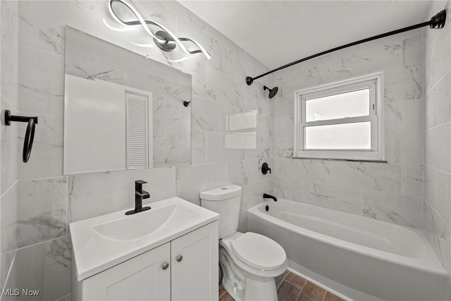 bathroom with toilet, tile walls, tub / shower combination, vanity, and wood finished floors