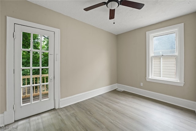 1344 E 112th St, Cleveland, OH 44106 - empty room with baseboards, a textured ceiling, and wood finished floors