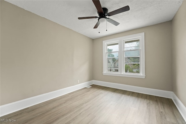 1344 E 112th St, Cleveland, OH 44106 - empty room featuring light wood finished floors, a textured ceiling, and baseboards