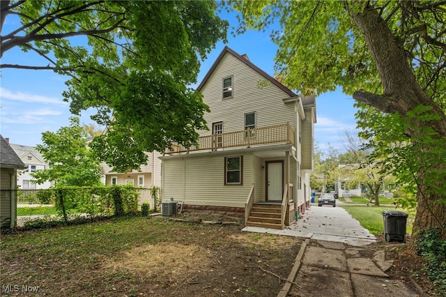 1344 E 112th St, Cleveland, OH 44106 - rear view of house featuring cooling unit, driveway, a balcony, and fence