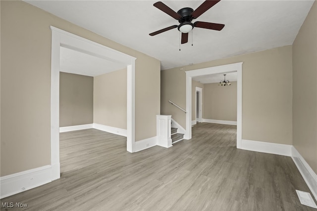 1344 E 112th St, Cleveland, OH 44106 - spare room with ceiling fan with notable chandelier, wood finished floors, and baseboards