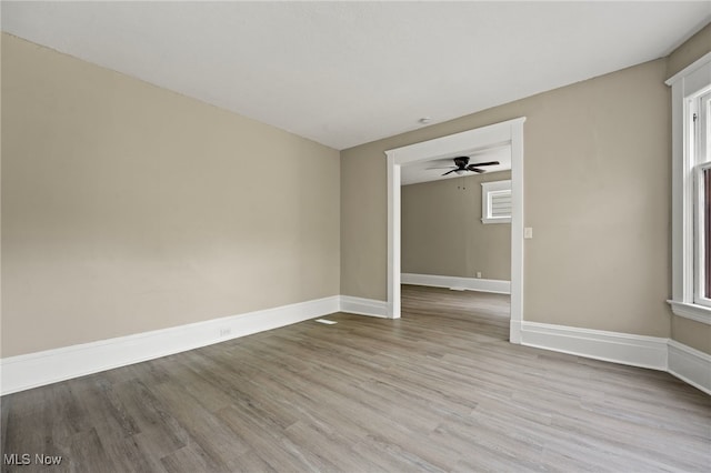 1344 E 112th St, Cleveland, OH 44106 - unfurnished room with a ceiling fan, baseboards, and light wood finished floors