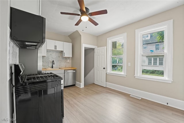 1344 E 112th St, Cleveland, OH 44106 - kitchen featuring a ceiling fan, white cabinetry, light wood finished floors, decorative backsplash, and dishwasher