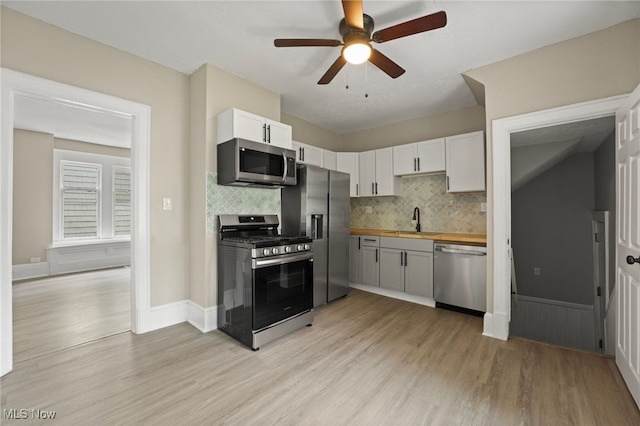 1344 E 112th St, Cleveland, OH 44106 - kitchen with light wood-style flooring, a sink, appliances with stainless steel finishes, butcher block counters, and ceiling fan