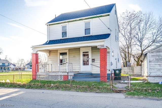 323 Belden Ave NE, Canton, OH 44704 - view of front of home featuring a porch, a fenced front yard, and a shingled roof