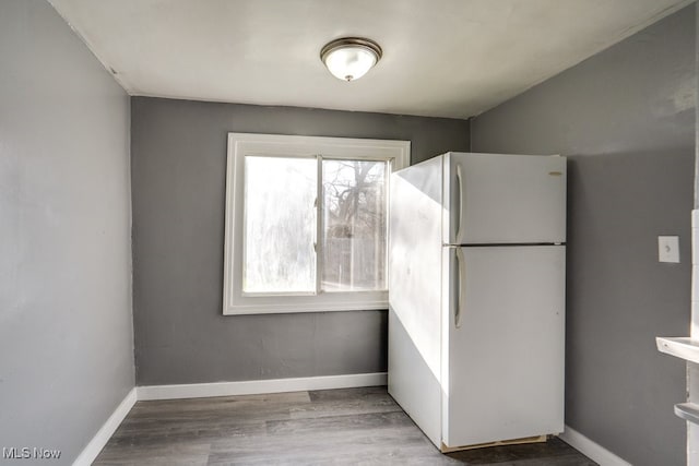 323 Belden Ave NE, Canton, OH 44704 - kitchen with wood finished floors, baseboards, and freestanding refrigerator