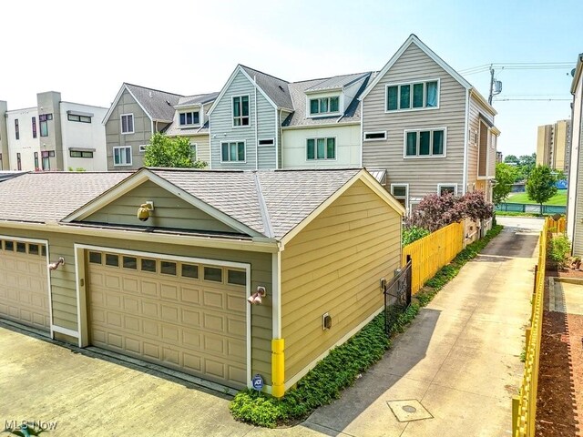1581 E 118th St, Cleveland, OH 44106 - exterior space featuring a residential view, a shingled roof, and a garage