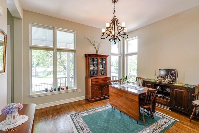 1581 E 118th St, Cleveland, OH 44106 - dining space featuring an inviting chandelier, baseboards, and light wood finished floors