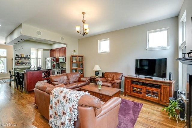 1581 E 118th St, Cleveland, OH 44106 - living area featuring a chandelier and light wood finished floors