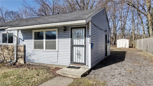 view of shed featuring fence