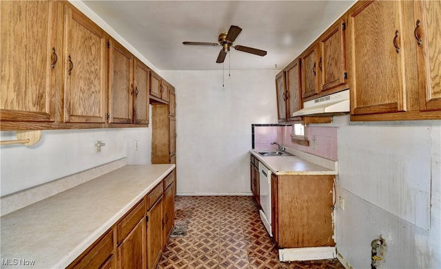 kitchen featuring under cabinet range hood, ceiling fan, brown cabinetry, and light countertops