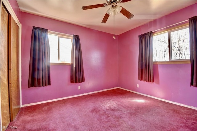 unfurnished room featuring baseboards, carpet, and ceiling fan