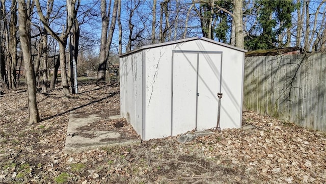 view of shed featuring fence
