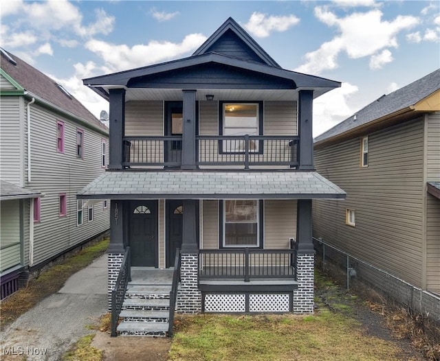 view of front of house with a porch and a shingled roof