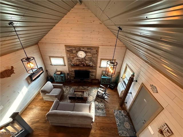 16223 Wooly Bear Ln, Kimbolton, OH 43749 - living room featuring wood walls, wood finished floors, high vaulted ceiling, and a stone fireplace