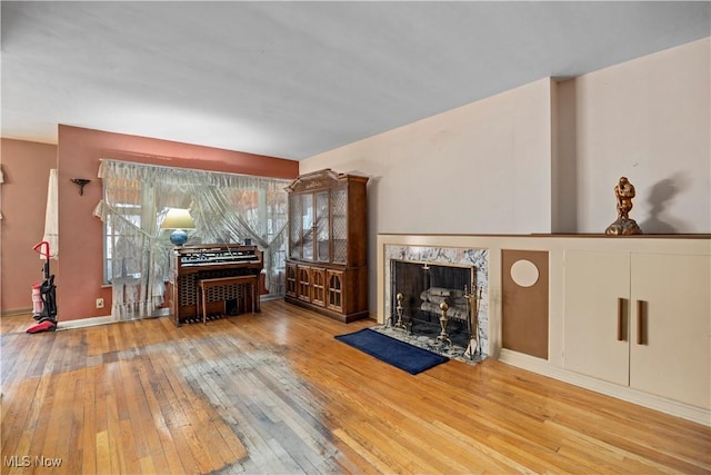 living area with a premium fireplace and hardwood / wood-style floors
