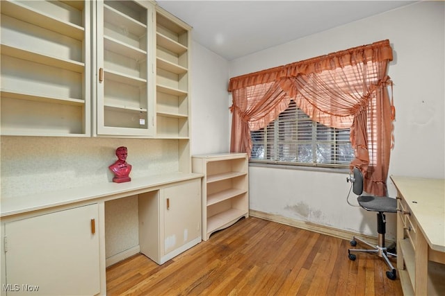 unfurnished office with light wood-type flooring