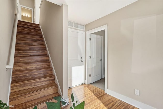 1228 W 74th St, Cleveland, OH 44102 - staircase featuring visible vents, baseboards, and wood finished floors