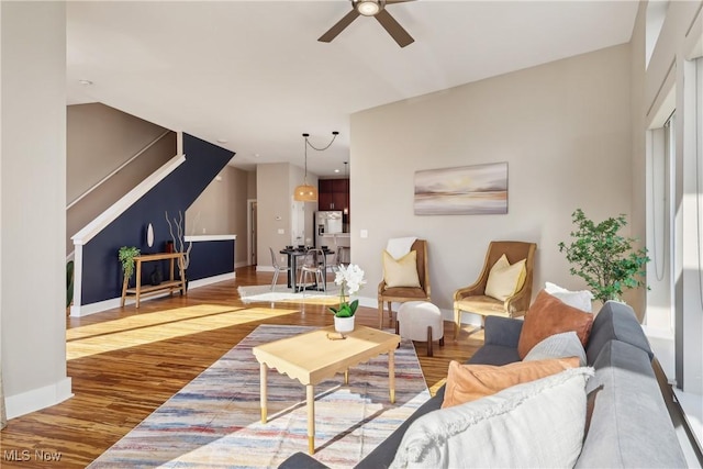 1228 W 74th St, Cleveland, OH 44102 - living area with wood finished floors, a ceiling fan, and baseboards