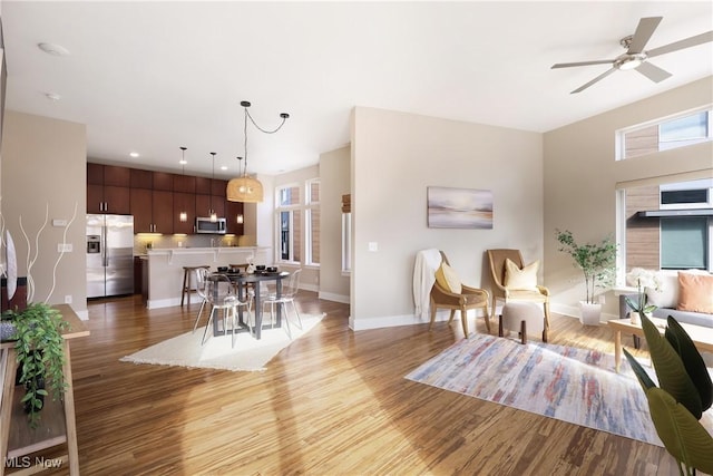 1228 W 74th St, Cleveland, OH 44102 - living area featuring light wood-style flooring, recessed lighting, a ceiling fan, and baseboards