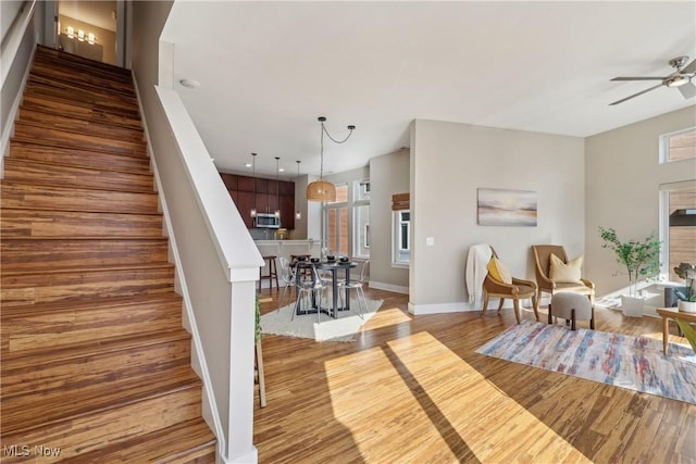 1228 W 74th St, Cleveland, OH 44102 - living room featuring a ceiling fan, wood finished floors, recessed lighting, baseboards, and stairs