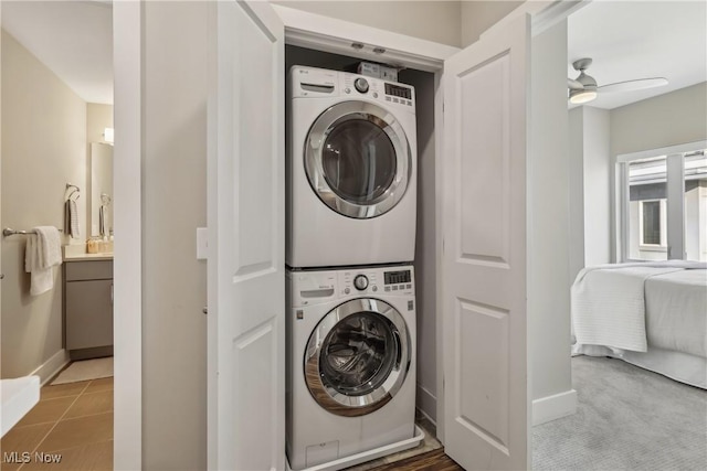 1228 W 74th St, Cleveland, OH 44102 - washroom featuring tile patterned floors, baseboards, laundry area, and stacked washer / dryer