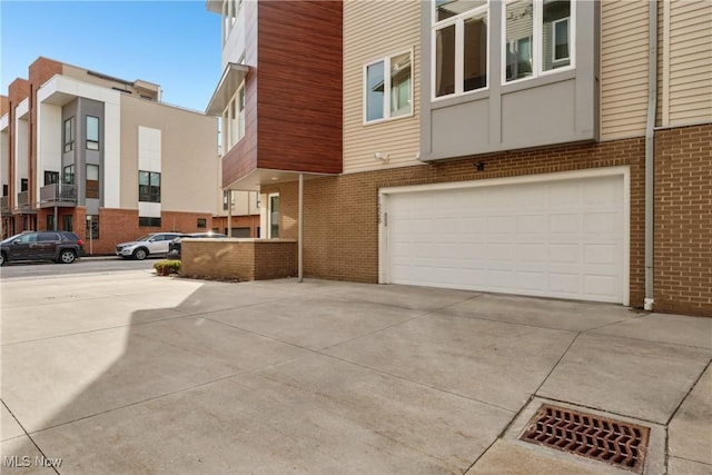 1228 W 74th St, Cleveland, OH 44102 - view of home's exterior with brick siding, an attached garage, and driveway