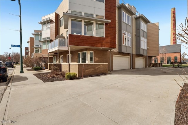 1228 W 74th St, Cleveland, OH 44102 - view of building exterior featuring driveway and an attached garage