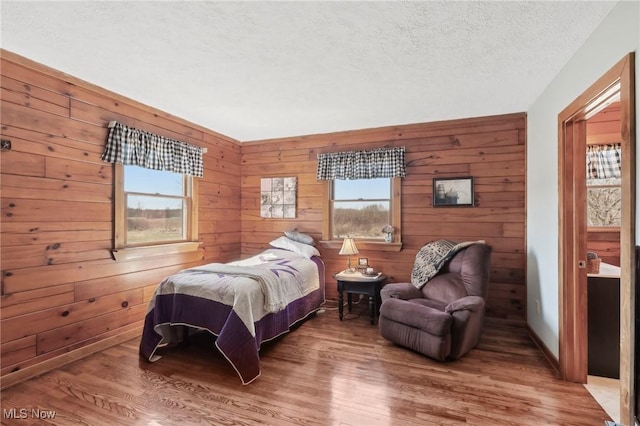 1525 Old Kyle Rd, Dorset, OH 44032 - bedroom with multiple windows, a textured ceiling, and wood finished floors