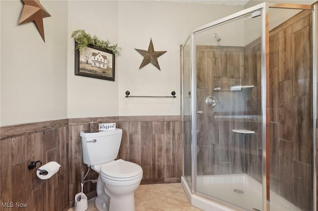 1525 Old Kyle Rd, Dorset, OH 44032 - bathroom with wainscoting, a shower stall, toilet, and tile walls
