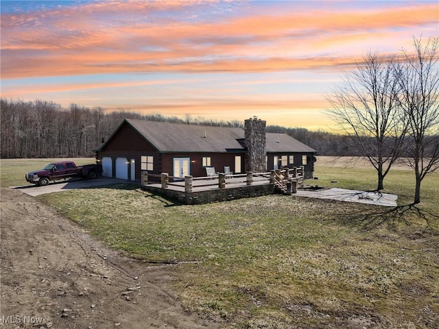 1525 Old Kyle Rd, Dorset, OH 44032 - view of front of house with a wooden deck, a lawn, log exterior, and dirt driveway