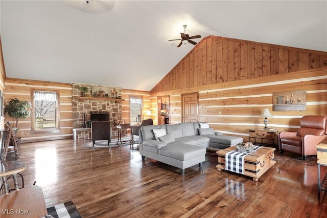1525 Old Kyle Rd, Dorset, OH 44032 - living room featuring high vaulted ceiling, wood-type flooring, wooden walls, a fireplace, and ceiling fan
